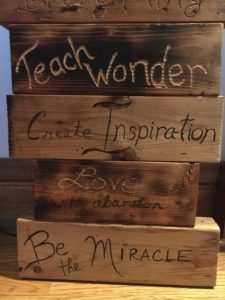 Examples of wood art, burnt and etched with inspirational messages
